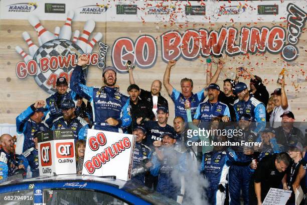 Martin Truex Jr., driver of the Auto-Owners Insurance Toyota, celebrates in Victory Lane after winning the Monster Energy NASCAR Cup Series Go...