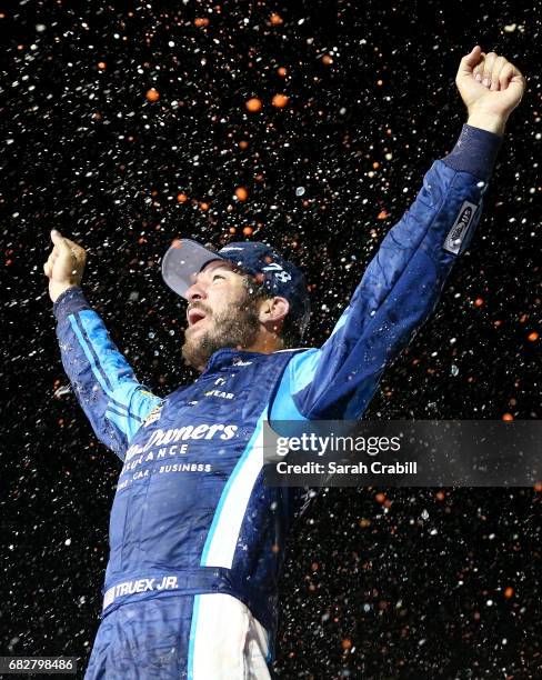 Martin Truex Jr., driver of the Auto-Owners Insurance Toyota, celebrates in Victory Lane after winning the Monster Energy NASCAR Cup Series Go...