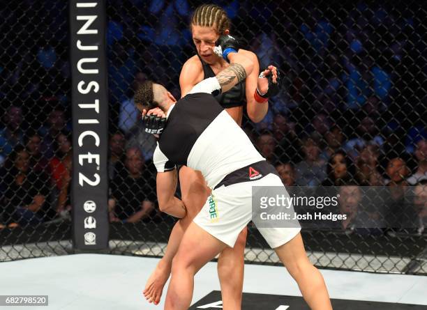 Jessica Andrade punchesJoanna Jedrzejczyk in their UFC women's strawweight championship fight during the UFC 211 event at the American Airlines...