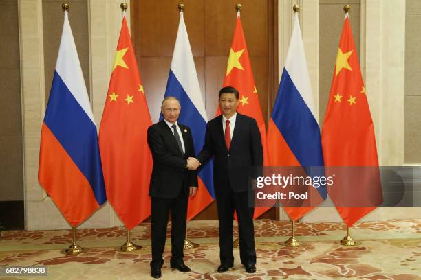 Russian President Vladimir Putin shakes hands with Chinese President Xi Jinping ahead a bilateral meeting at Diaoyutai State Guesthouse in Beijing,...