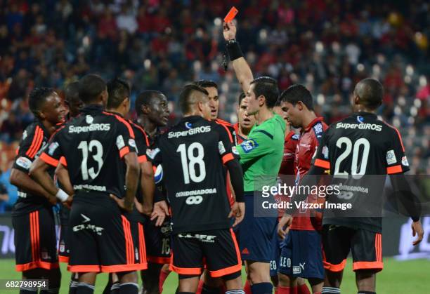 Referee Andres Rojas, shows the red card to Jonny Mosquera of America de Cali during a match between Independiente Medellin and America de Cali as...