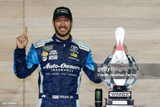 Martin Truex Jr., driver of the Auto-Owners Insurance Toyota, celebrates in Victory Lane after winning the Monster Energy NASCAR Cup Series Go...