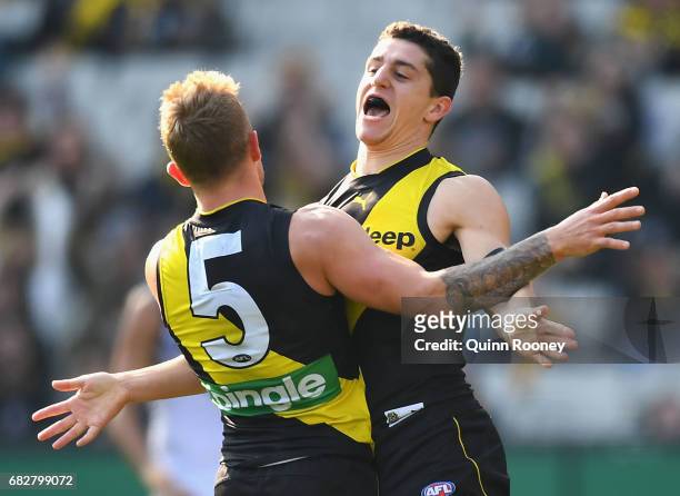 Jason Castagna of the Tigers is congratulated by Brandon Ellis after kicking a goal during the round eight AFL match between the Richmond Tigers and...