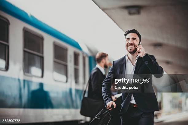 young businessman trying to catch the train - catching train stock pictures, royalty-free photos & images