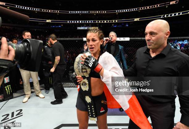 Joanna Jedrzejczyk celebrates her victory over Jessica Andrade in their UFC women's strawweight championship fight during the UFC 211 event at the...