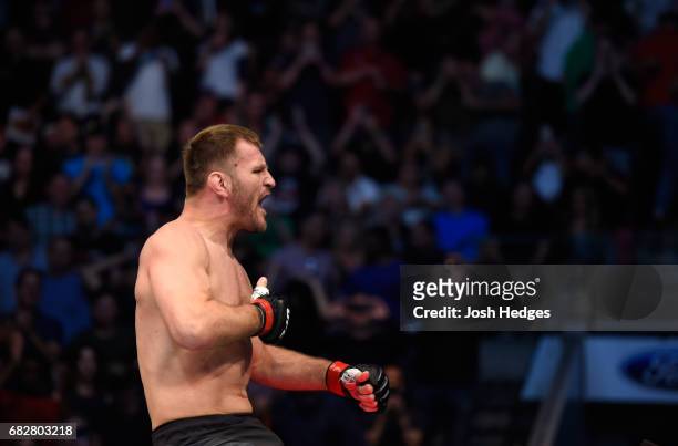 Stipe Miocic celebrates his TKO victory over Junior Dos Santos in their UFC heavyweight championship fight during the UFC 211 event at the American...