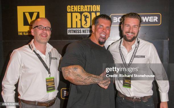 Professional bodybuilder Rich Piana poses with Executive Producers Nick Orton and Ollie Upton as he arrives to attend the premiere of 'Generation...