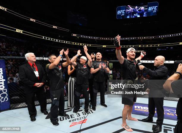 Stipe Miocic celebrates his TKO victory over Junior Dos Santos in their UFC heavyweight championship fight during the UFC 211 event at the American...