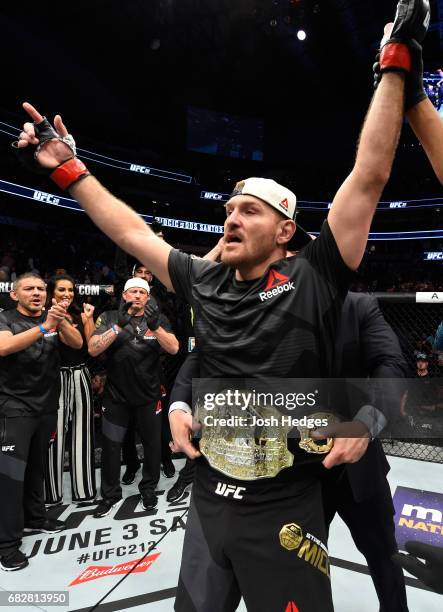 Stipe Miocic celebrates his TKO victory over Junior Dos Santos in their UFC heavyweight championship fight during the UFC 211 event at the American...