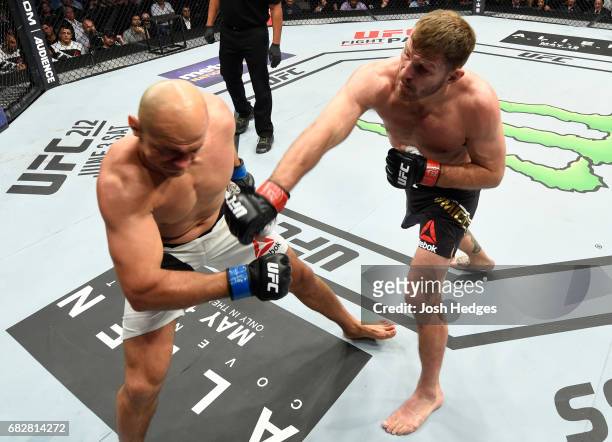 Stipe Miocic punches Junior Dos Santos in their UFC heavyweight championship fight during the UFC 211 event at the American Airlines Center on May...
