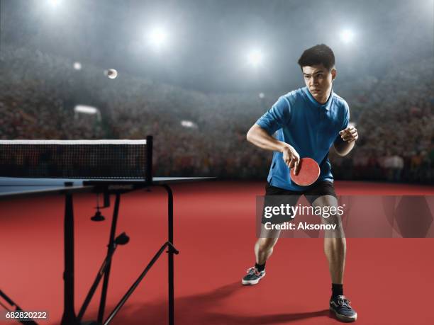 young asian ping pong player playing table tennis game - table tennis stock pictures, royalty-free photos & images