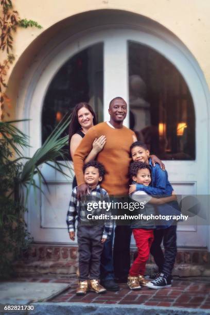 family of five standing together in a city