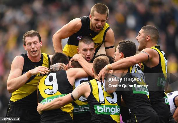 Brandon Ellis of the Tigers is congratulated by team mates after kicking a goal during the round eight AFL match between the Richmond Tigers and the...