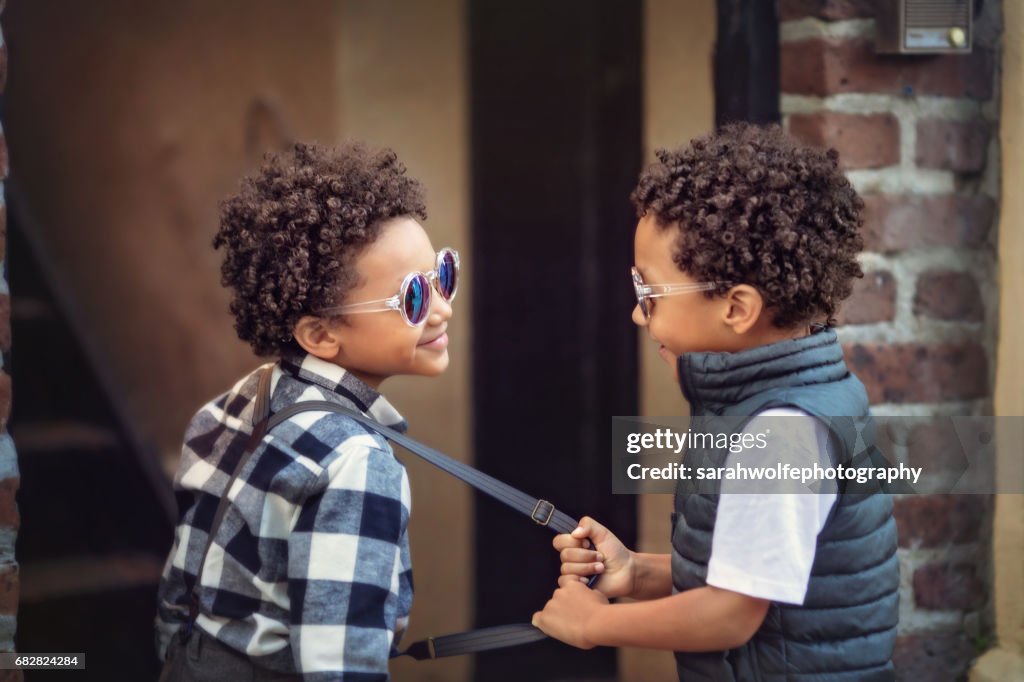 Child pulling on his twin brother's suspender