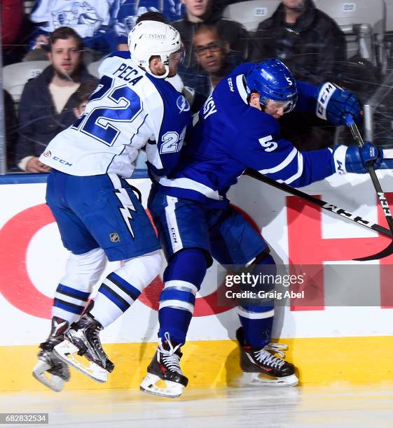 Steven Oleksy of the Toronto Marlies puts a hit on Matthew Peca of the Syracuse Crunch during game 4 action in the Division Final of the Calder Cup...