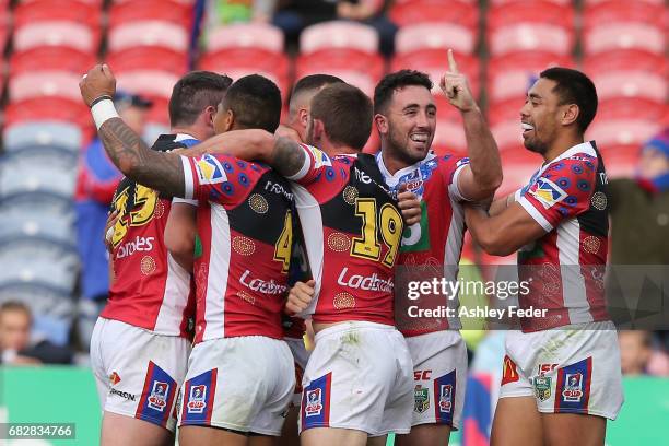 Knights players celebrate a try during the round 10 NRL match between the Newcastle Knights and the Canberra Raiders at McDonald Jones Stadium on May...