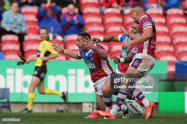 Joe Wardle of the Knights celebrates his try during the round 10 NRL match between the Newcastle Knights and the Canberra Raiders at McDonald Jones...