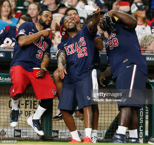 Kareem Jackson of the Houston Texans, center, takes a selfie with Eddie Pleasant and D.J. Reader during the JJ Watt Charity Softball Game at Minute...