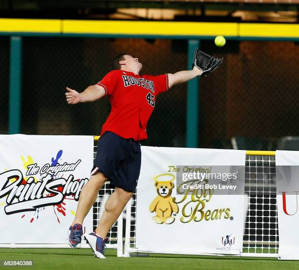 Jay Prosch of the Houston Texans just misses a catch in center field at the JJ Watt Charity Softball Game at Minute Maid Park on May 13, 2017 in...