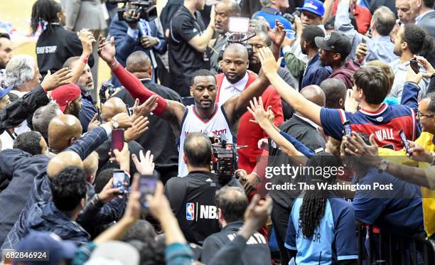 Washington Wizards guard John Wall is greeted by the fans after their win over the Boston Celtics in game six of the Eastern Conference semifinals in...