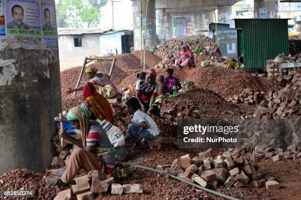 Bangladeshi women, Men and Childs break bricks at Demra brick breaking yard in Dhaka, Bangladesh, On May 13, 2017. With over half of the population...