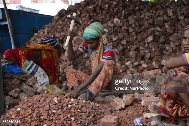 Bangladeshi women, Men and Childs break bricks at Demra brick breaking yard in Dhaka, Bangladesh, On May 13, 2017. With over half of the population...