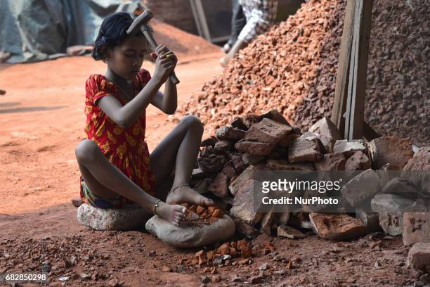 Bangladeshi women, Men and Childs break bricks at Demra brick breaking yard in Dhaka, Bangladesh, On May 13, 2017. With over half of the population...