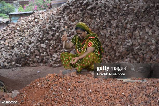 Bangladeshi women, Men and Childs break bricks at Demra brick breaking yard in Dhaka, Bangladesh, On May 13, 2017. With over half of the population...