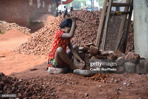 Bangladeshi women, Men and Childs break bricks at Demra brick breaking yard in Dhaka, Bangladesh, On May 13, 2017. With over half of the population...