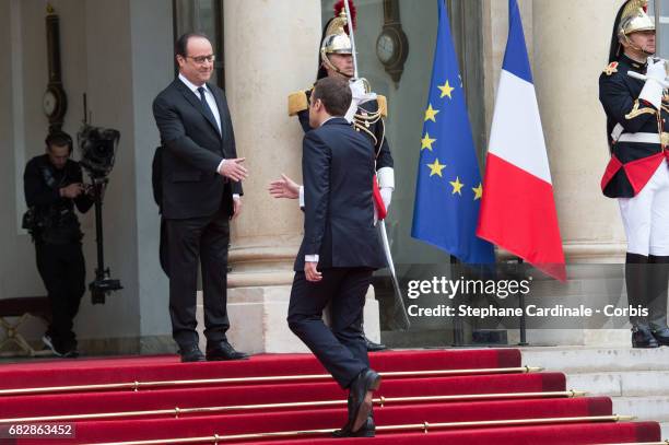 French newly elected President Emmanuel Macron is welcomed by his predecessor Francois Hollande as he arrives at the Elysee Presidential Palace for...