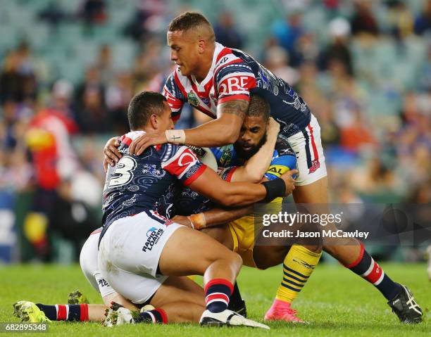 Michael Jennings of the Eels is tackled by Sio Siua Taukeiaho and Kane Evans of the Roosters during the round 10 NRL match between the Sydney...