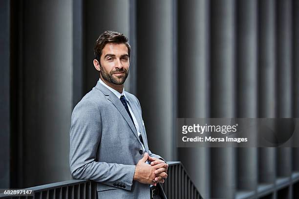 confident businessman with hands clasped outdoors - portrait man suit stock pictures, royalty-free photos & images