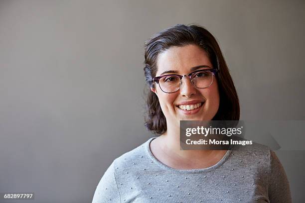 professional smiling over gray background - woman portrait plain background stock pictures, royalty-free photos & images