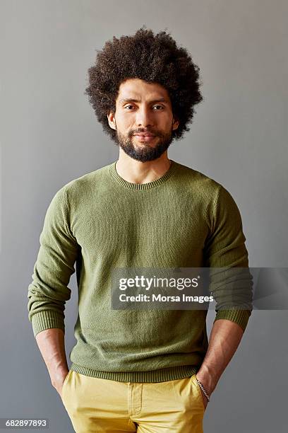 businessman with hands in pockets over gray - black hair imagens e fotografias de stock