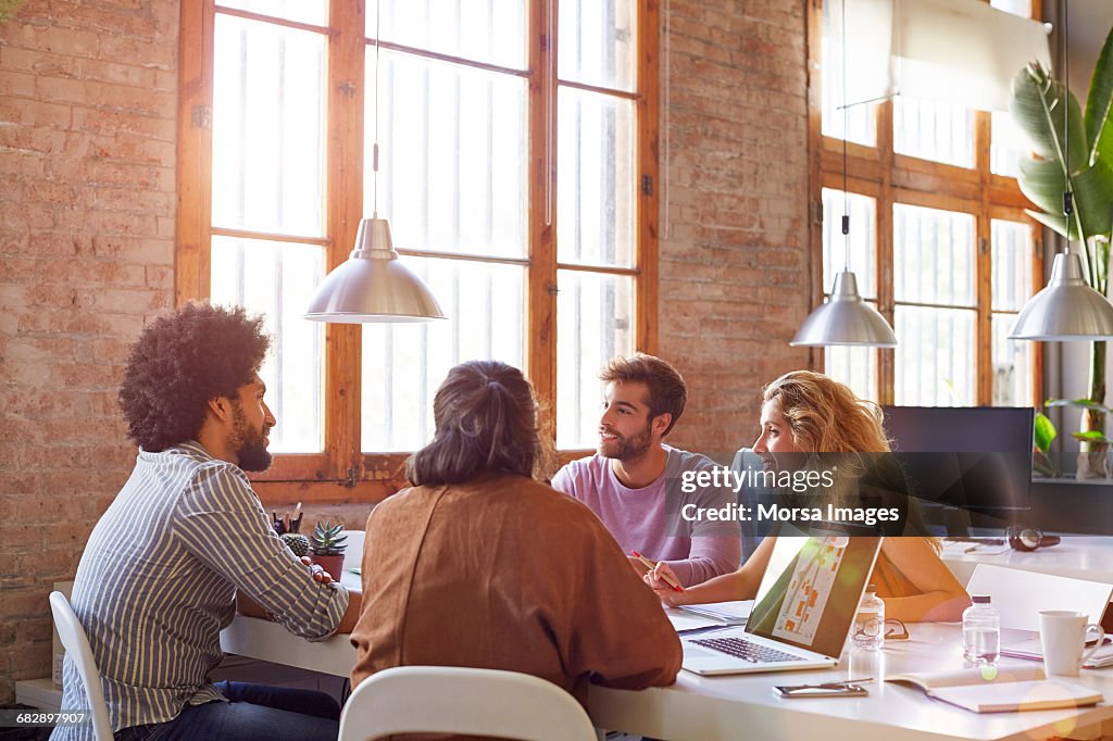 Professionals sitting at desk in office