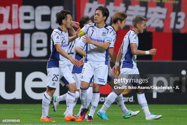 Jungo Fujimoto of Gamba Osaka celebrates scoring the opening goal with his team mate Yasuhito Endo during the J.League J1 match between Consadole...