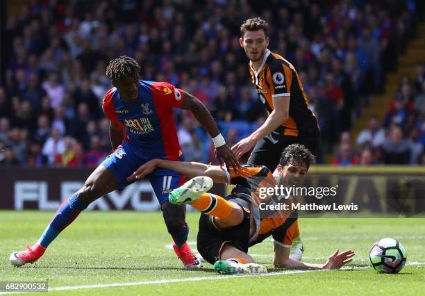 Wilfried Zaha of Crystal Palace and Andrea Ranocchia of Hull City battle for possession during the Premier League match between Crystal Palace and...