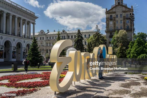 People pose for pictures in front of a Eurovision sign on Independence Square on May 11, 2017 in Kiev, Ukraine. Ukraine is the 62nd host of the...