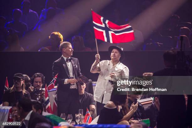 Vocalist Aleksander Walmann of JOWST, the contestant from Norway, waves a Norwegian flag in the green room at the Eurovision Grand Final on May 14,...