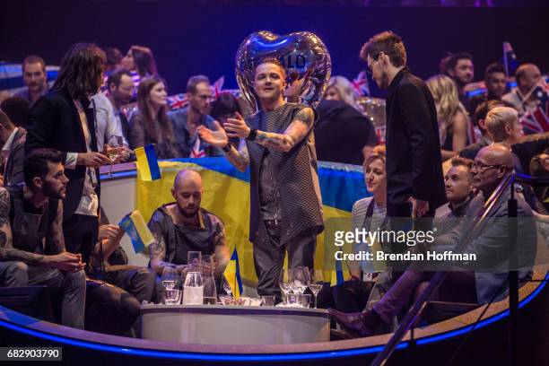 Zhenia Halych , lead singer of the band O.Torvald, the contestant from Ukraine, and other band and delegation members sit in the green room at the...