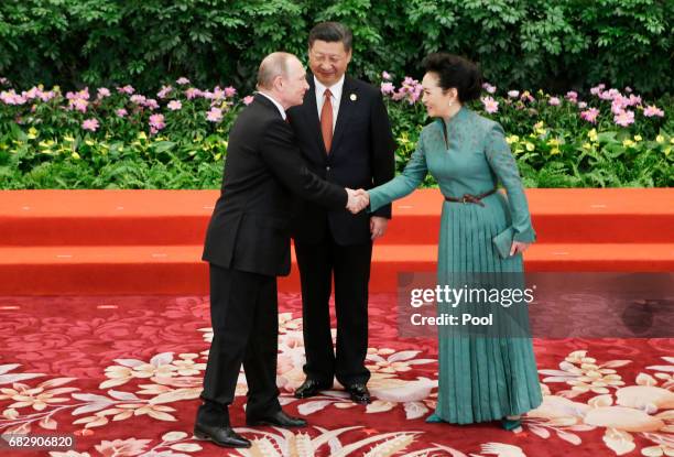 Chinese President Xi Jinping and wife Peng Liyuan welcome Russian President Vladimir Putin at the welcoming banquet for the Belt and Road Forum on...