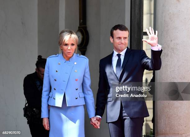 New French president Emmanuel Macron and his wife Brigitte Trogneux Macron pose after the handover ceremony at the Elysee Palace in Paris, France on...