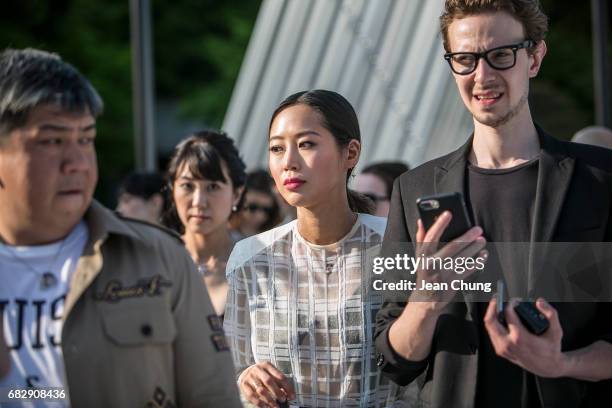 Aimee Song, center, attends the Louis Vuitton Resort 2018 show at the Miho Museum on May 14, 2017 in Koka, Japan.