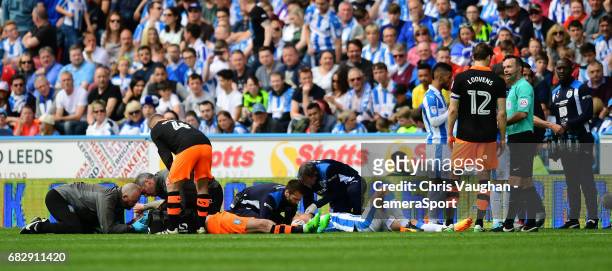 Sheffield Wednesday's Steven Fletcher, left, and Huddersfield Town's Chris Lowe both receive treatment for head injuries during the Sky Bet...