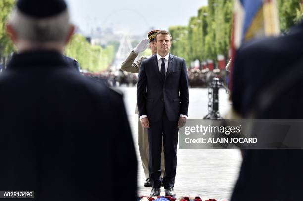 French President Emmanuel Macron observes a minute of silence in front of Chief of the Defence Staff French army General Pierre de Villiers after...