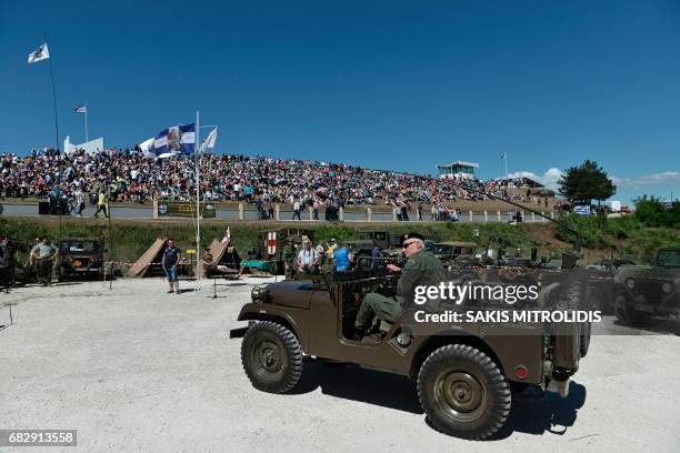 People dressed with World War II uniforms take part in a ceremony called "Roupel 1941- The Revival," organized by the municipality of Sintiki for the...