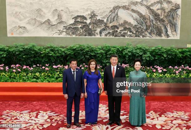 Chinese President Xi Jinping and wife Peng Liyuan welcome Philippine President Rodrigo Duterte and his partner Honeylet Avancena at the welcoming...