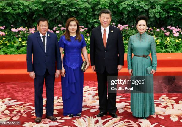 Chinese President Xi Jinping and wife Peng Liyuan welcome Philippine President Rodrigo Duterte and his partner Honeylet Avancena at the welcoming...