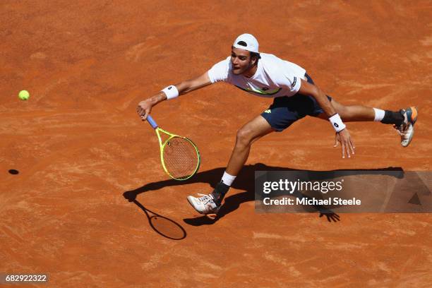 Matteo Berrettini of Italy stretches in vain during his first round match against Fabio Fognini of Italy on Day Two of The Internazionali BNL...