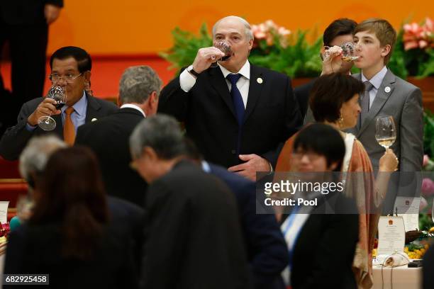 Belarus President Alexander Lukashenko, his son Nikolai and Cambodia's Prime Misnietr Hun Sen make a toast during the welcoming banquet for the Belt...